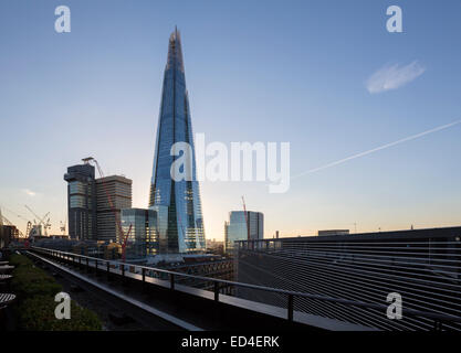 Shard of Glass building towering over other buildings on south side of Thames at dusk in London, England, UK Stock Photo