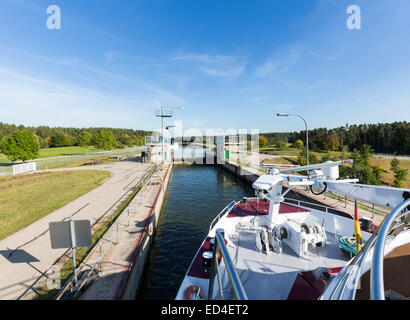 Cruise barge or boat leaves Hilpotstein lock on Rhine Main Danube canal near the European Continental Divide or Watershed at Hil Stock Photo