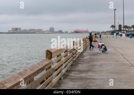 Cold, rainy day does not deter fishing from piers on Pelican Island, Galveston, Texas. Stock Photo