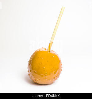 toffee apple orange on white background (isolated) Stock Photo