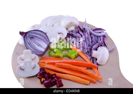 Chopped onions, mushrooms, carrots, peppers on a cutting board isolated on white background Stock Photo