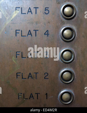 A brass plate with buzzers for flats 1 to 5 with buttons linked to bells Stock Photo