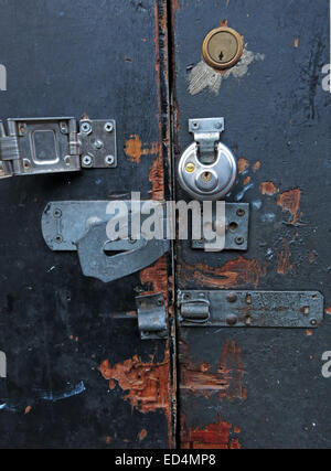 Ultra secure door with many locks, yale, padlock and bolts Stock Photo