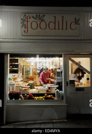 Brighton UK - The Foodilic Cafe restaurant with man using the buffet food bar in window Stock Photo