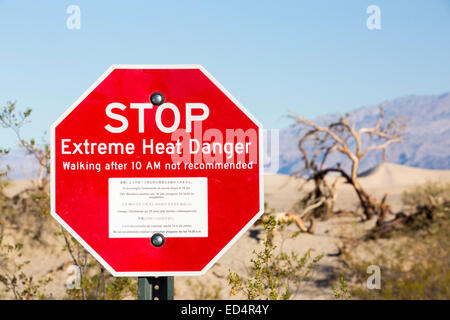 An extreme heat danger sign in Death Valley which is the lowest, hottest, driest place in the USA, with an average annual rainfall of around 2 inches, some years it does not receive any rain at all. Stock Photo