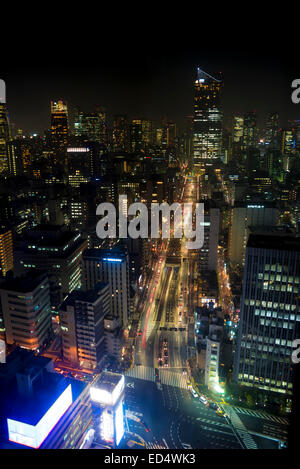Night scene of a main road leading into Shiodome district and Shimbashi station, Tokyo, Japan. Stock Photo
