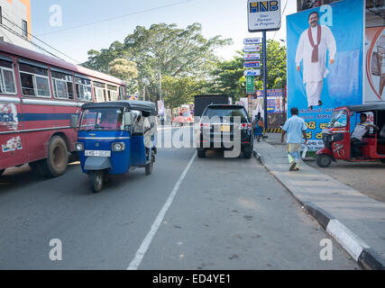 Street view with traffic and election poster of ruling president and Tangalle born Mahinda Rajapaksa in Tangalle, Sri Lanka. Stock Photo