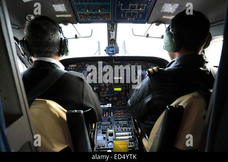 pilots in a propeller airplane flying to Lukla Tenzing Hillary airport with the dramatic Himalaya mountains, Himalayas, Nepal, A Stock Photo