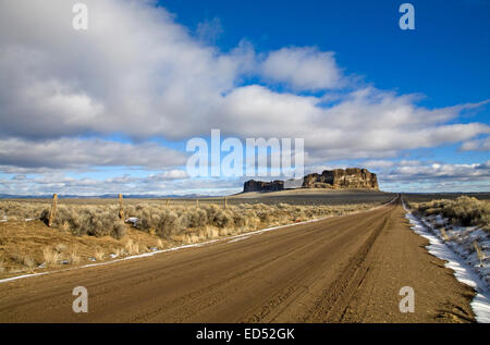 A lonely road at Fort Rock Natural Area, is a volcanic uplift in the high desert of the Oregon Outback, central Oregon. Stock Photo
