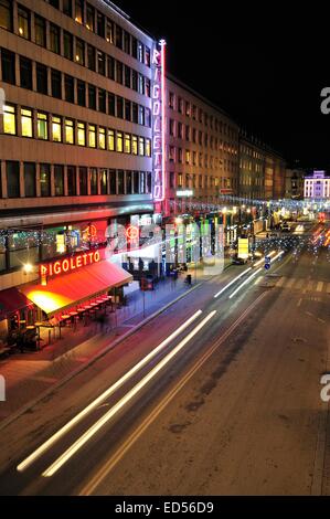 Stockholm, Sweden - December 7, 2013: Night traffic on Kungsgatan in central Stockholm. Cars, pedestrians, taxis in traffic clos Stock Photo