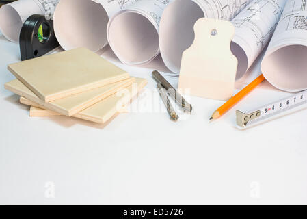 Drawing rolls, construction tools and materials composition Stock Photo