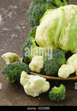 organic cabbage cauliflower and green broccoli on old iron table Stock Photo