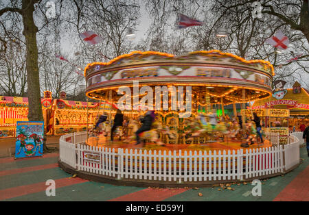 LONDON HYDE PARK WINTER WONDERLAND A SPINNING CAROUSEL  OR MERRY GO ROUND WITH RIDERS Stock Photo