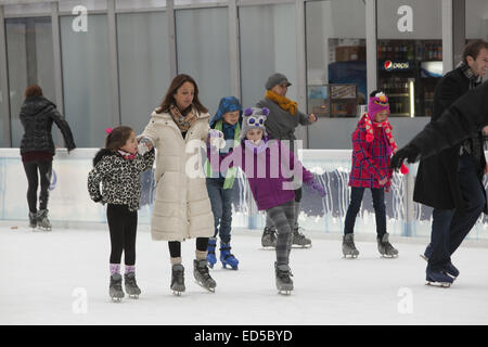 New Yorkers and tourists alike enjoy ice skating at Bryant Park during the holiday season in Manhattan. Stock Photo