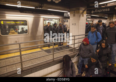 Subway riders  at the 42nd St. station on the Lexington Line in Manhattan at the evening rush hour. Stock Photo