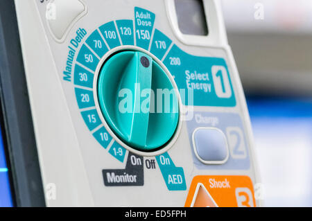 Defibrillator sitting ready for use on a hospital Crash Trolley. Stock Photo