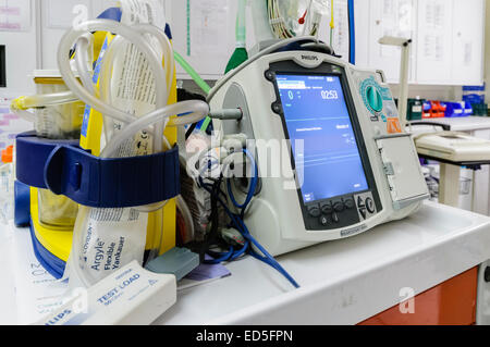 Defibrillator sitting ready for use on a hospital Crash Trolley. Stock Photo