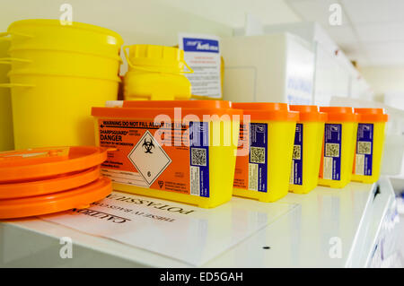 Unused sharps boxes in a hospital clinical room. Stock Photo