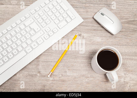 desk with keyboard, mouse and coffee Stock Photo