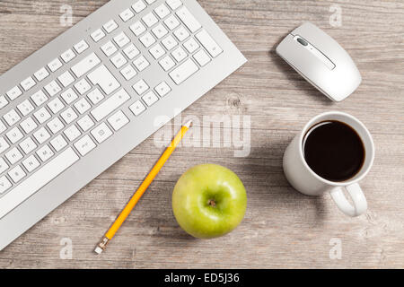 desk with keyboard and mouse and green apple Stock Photo