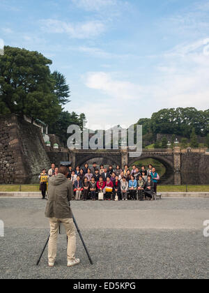 Tourist group taking pictures near Tokyo Imperial Palace Stock Photo