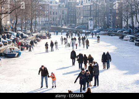 Amsterdam Ice Skating on a frozen Canal in winter. Keizersgracht Canal. Stock Photo