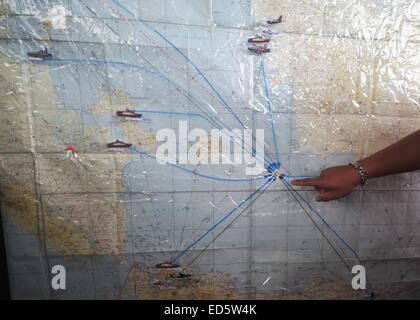 Surabaya, Indonesia. 29th Dec, 2014. A staff member of Indonesian search and rescue team shows the possible location of AirAsia flight QZ8501 at Juanda International Airport in Surabaya, Indonesia, Dec. 29, 2014. Air Asia Indonesia has released information about the 162 passengers and crew members on flight QZ8501, which lost contact with the air traffic control Sunday morning. Credit:  Zulkarnain/Xinhua/Alamy Live News Stock Photo