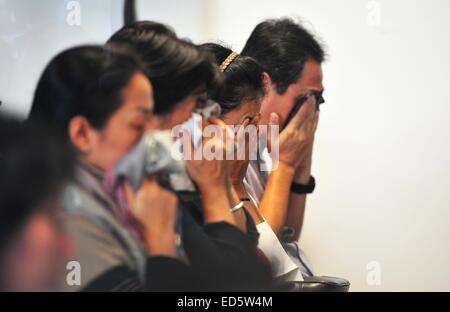 Surabaya, Indonesia. 29th Dec, 2014. Family members of people on AirAsia flight QZ8501 pray togather at Juanda International Airport in Surabaya, Indonesia, Dec. 29, 2014. Air Asia Indonesia has released information about the 162 passengers and crew members on flight QZ8501, which lost contact with the air traffic control Sunday morning. Credit:  Zulkarnain/Xinhua/Alamy Live News Stock Photo