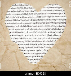 a heart-shaped hole on an old paper with a printed paper with letters in the background, with a retro effect Stock Photo