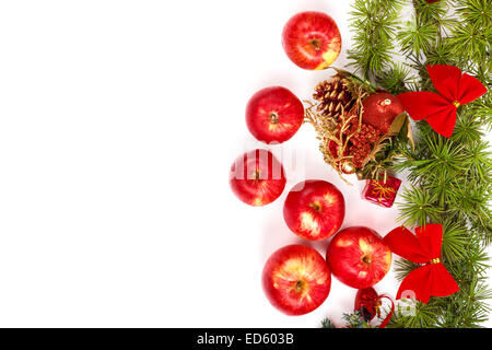 Christmas decoration with green pine or fir and many scattered red apples. Holiday decorations isolated on white background. Emp Stock Photo