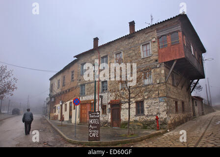 Lonely old man walking at misty Agios Germanos village,  Prespes lakes, Florina, Macedonia, Greece. Stock Photo