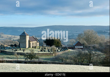 Llanddewi'r Cwm, Powys, UK. 29th December, 2014. UK weather.  The sun rises on St David's Church. After a cold night with temperatures dropping to minus 4 degrees Centigade, Mid Wales wakes up to a heavy frost. Credit:  Graham M. Lawrence/Alamy Live News. Stock Photo