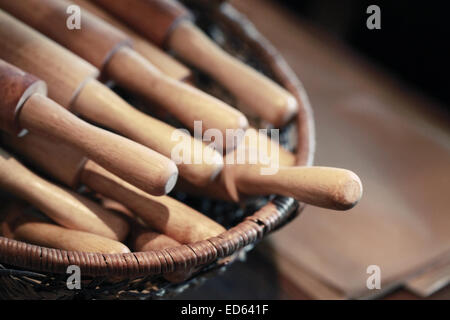 Wooden rolling pin in the basket. Selective focus. Vintage toned photo filter effect Stock Photo