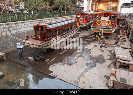 Hangzhou, China - December 5, 2014: Traditional Chinese wooden recreation boats under renovation in the shipyard. West Lake coas Stock Photo