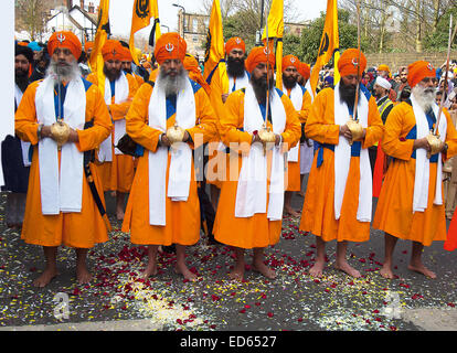 The Five Beloved Ones, known as the Panj Pyare, line up for the Sikh New Year procession in Southall carrying their swords. Stock Photo