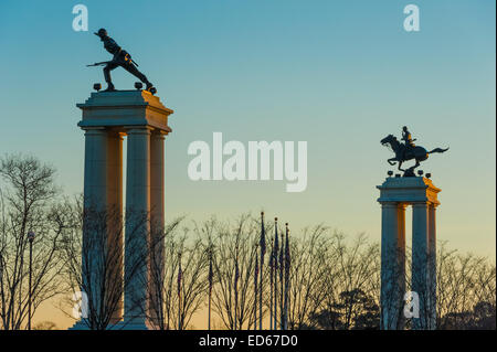 Towering monuments at the Gateway entrance to the Fort Benning Army base stand tall in the first light of dawn. Stock Photo