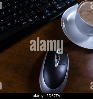 keyboard, cup coffee and mouse on desk Stock Photo