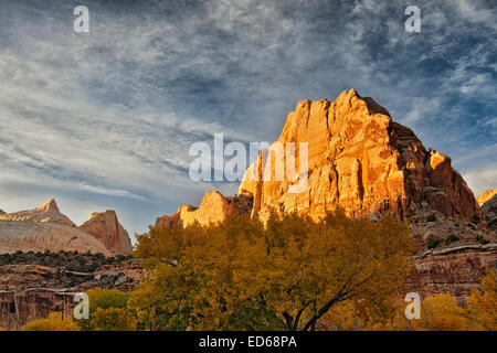 Autumn’s evening light bathes the sandstone domes and spires of Utah’s Capitol Reef National Park. Stock Photo