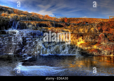 The River Swale close to it's source in Upper Swaledale very very close to be 100% frozen. Stock Photo