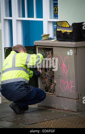 A BT Openreach telecoms engineer working on a broadband connection street cabinet. UK Stock Photo