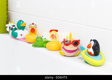 rubber ducks and other toys along side of a bath