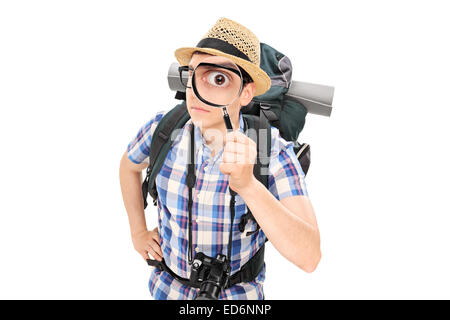 Curious tourist looking through a magnifying glass isolated on white background Stock Photo