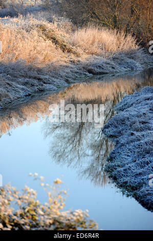 Alfriston, Sussex, UK. 30th December, 2014. UK weather. Reflections of the frost in the River Cuckmere near Alfiston in East Sussex as temperatures remain well below zero this morning . Stock Photo