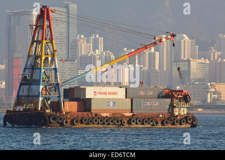 Container barge with derrick crane on Victoria Harbor, Hong Kong Island ...