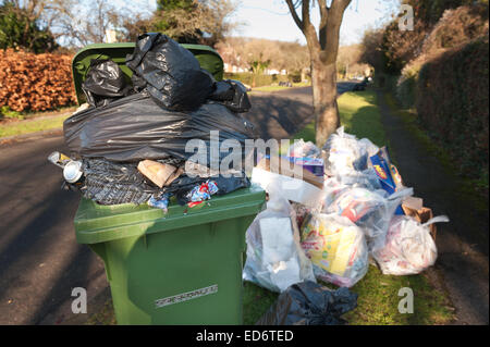 build up of household rubbish refuge causing blockage and pile up of waste preventing access for disabled on council pavement Stock Photo