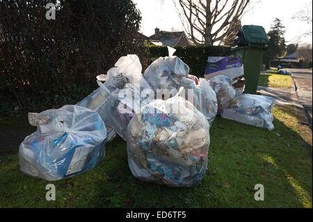 build up of household rubbish refuge causing blockage and pile up of waste preventing access for disabled on council pavement Stock Photo