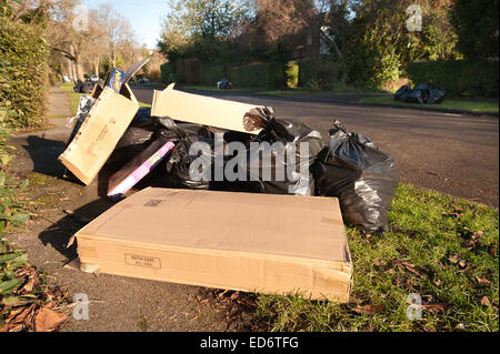 build up of household rubbish refuge causing blockage and pile up of waste preventing access for disabled on council pavement Stock Photo