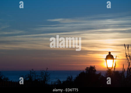 A Street light at sunset in Naples. Italy  in an amazing sky Stock Photo