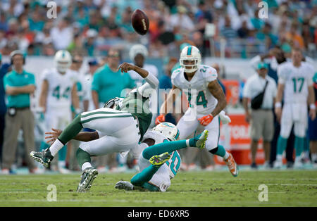 Dec. 28, 2014 - Miami Gardens, Florida, U.S. - New York Jets quarterback Geno Smith (7) fumbles as he is taken down by Miami Dolphins strong safety Reshad Jones (20) in the second quarter at Sun Life Stadium in Miami Gardens, Florida on December 28, 2014. The Dolphins recovered the fumble. (Credit Image: © Allen Eyestone/The Palm Beach Post/ZUMA Wire) Stock Photo