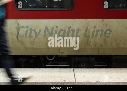 Berlin, Germany. 11th Dec, 2014. A man walks past the night-train to Paris at the main station in Berlin, Germany, 11 December 2014. PHOTO: PAUL ZINKEN/dpa/Alamy Live News Stock Photo